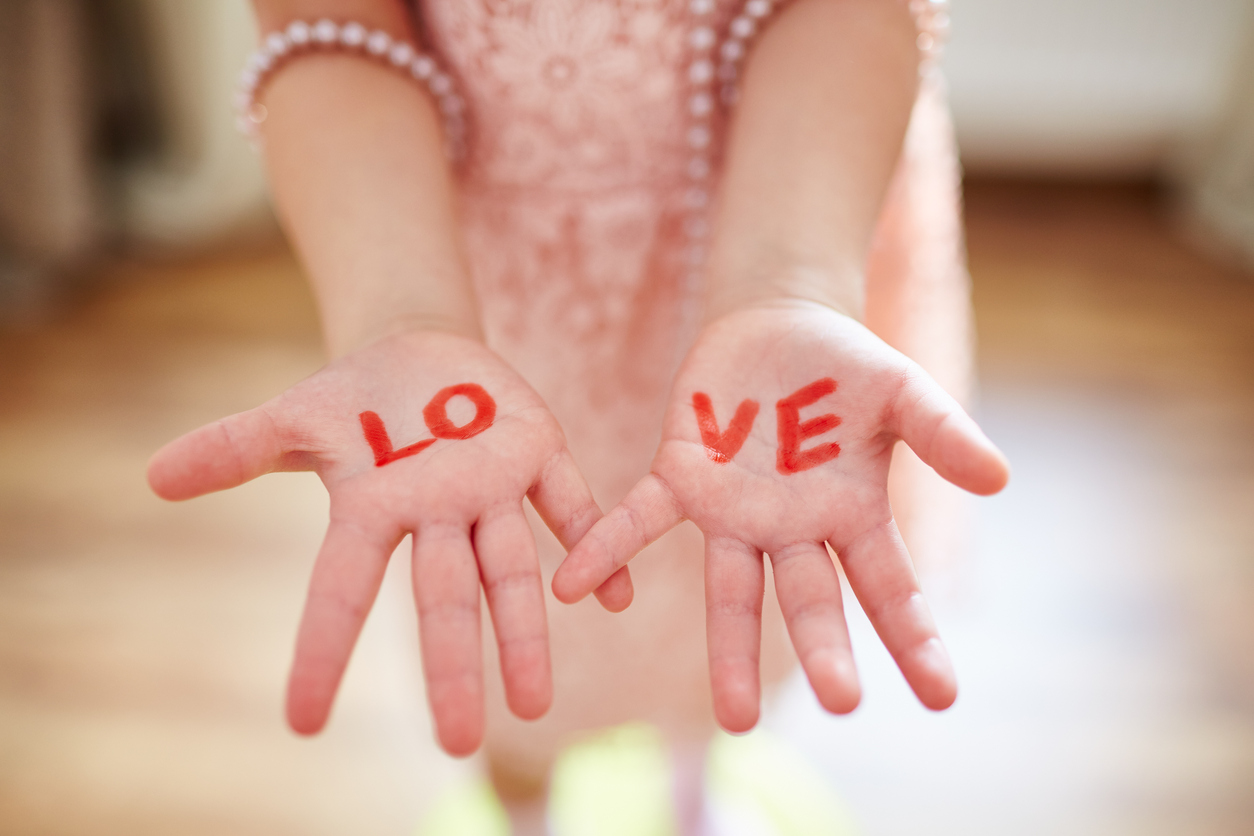 Woman's hands with the word Love written on them