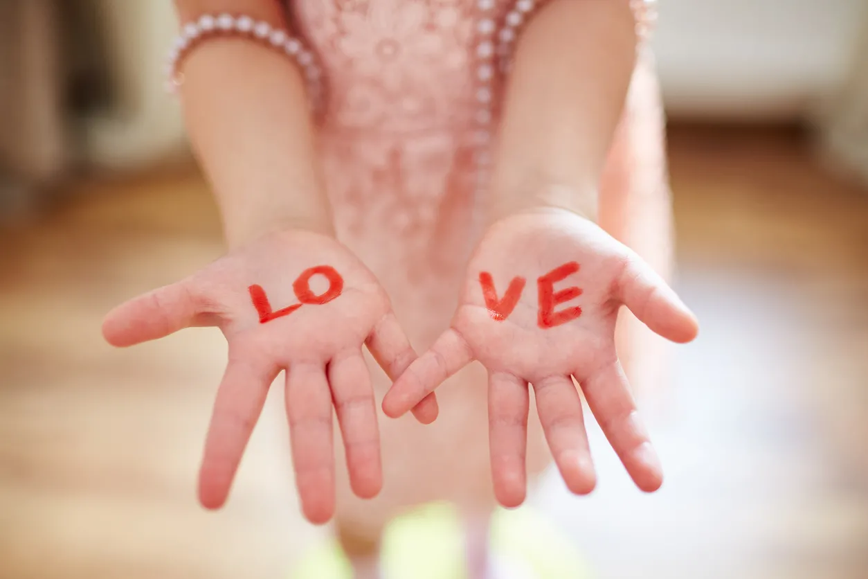 Woman's hands with the word Love written on them