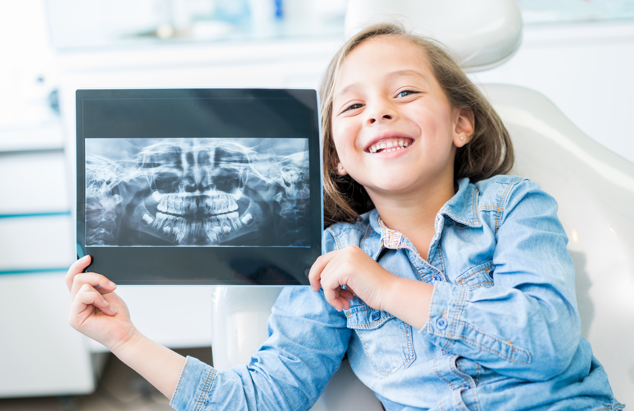 Young girl smiling holding an Xray