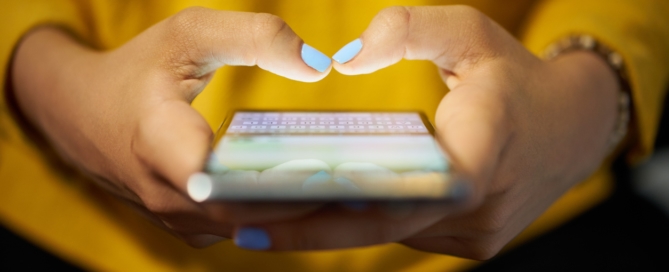 Closeup of woman's hands texting