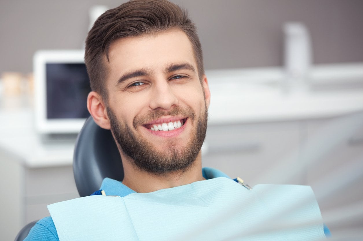 Male teenager with beard in dentist chair