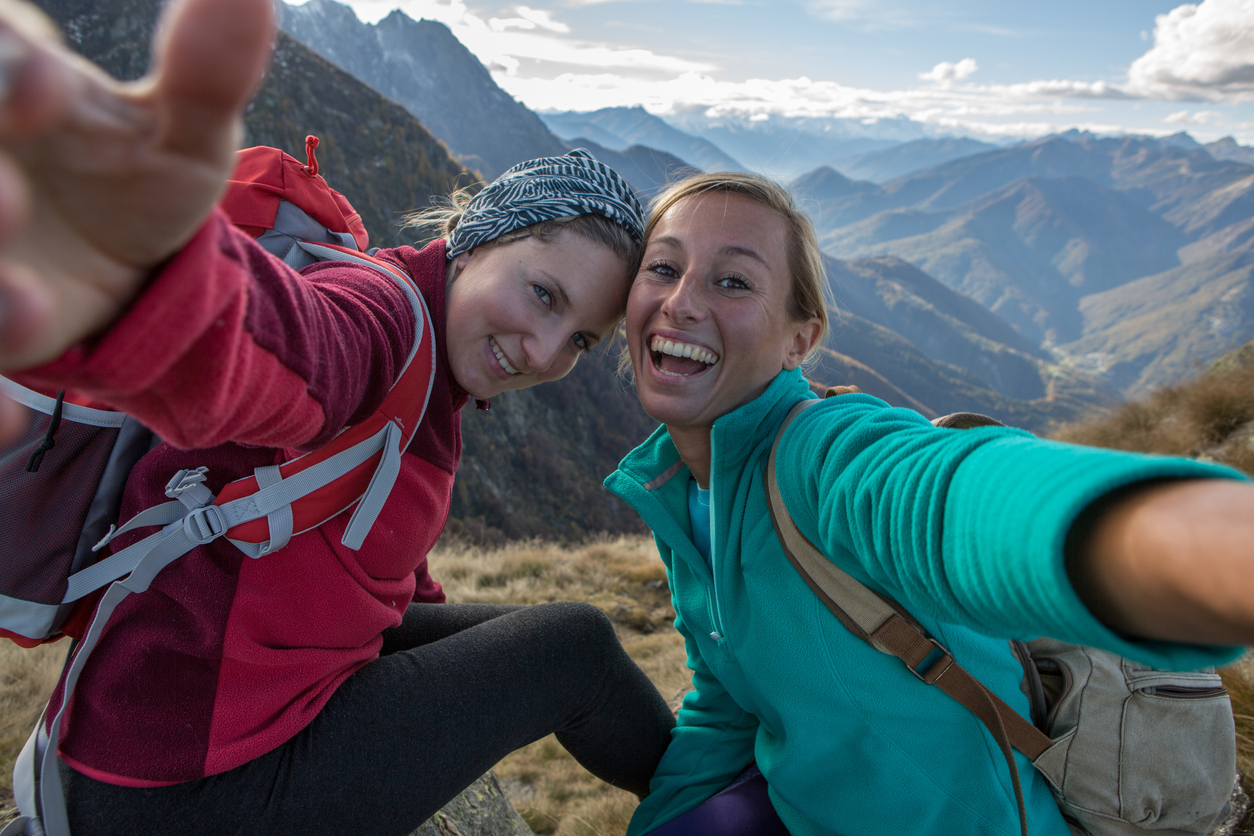 Two women smiling in mountains