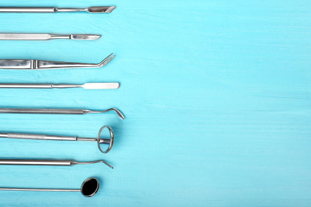 Dental tools on blue background