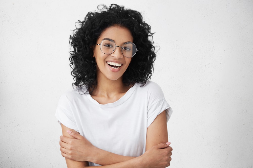 Young adult woman round glasses smiling